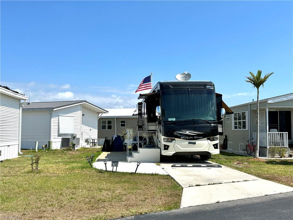 a view of a house with backyard and sitting area