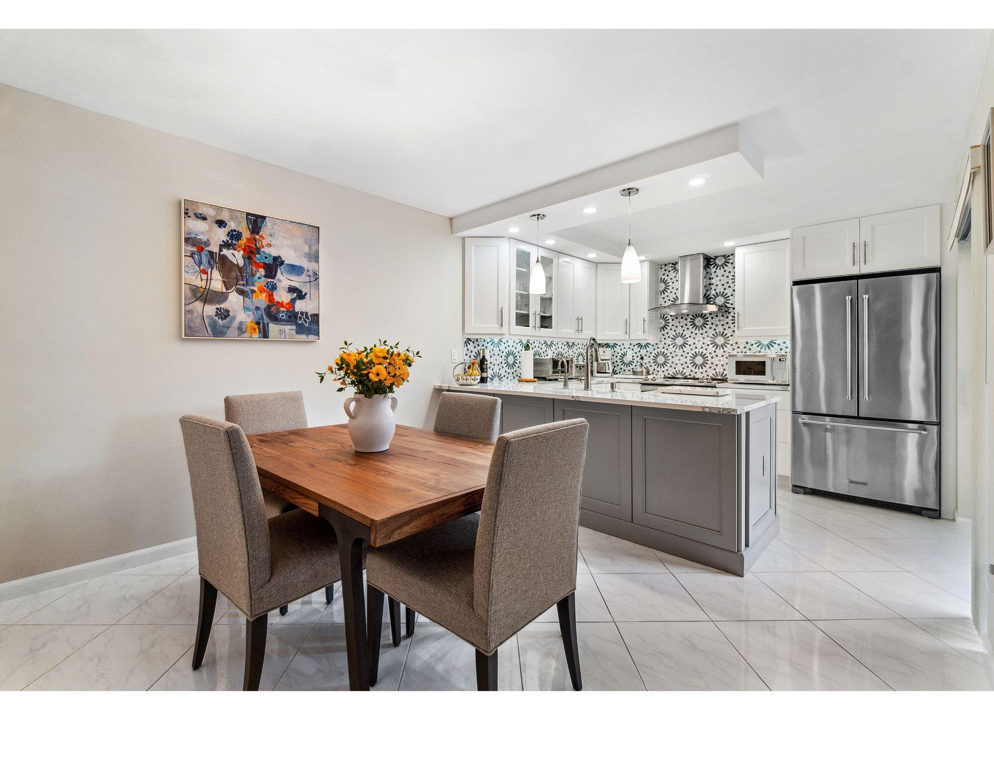 a kitchen with a dining table and chairs