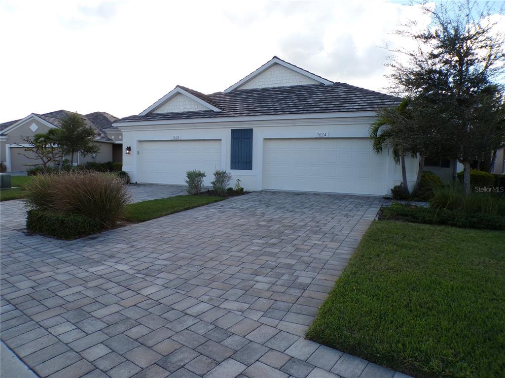 a front view of a house with a yard and a garage