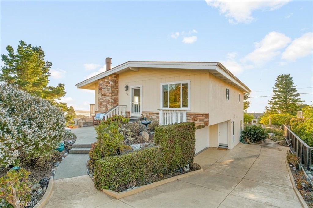 a front view of a house with garden