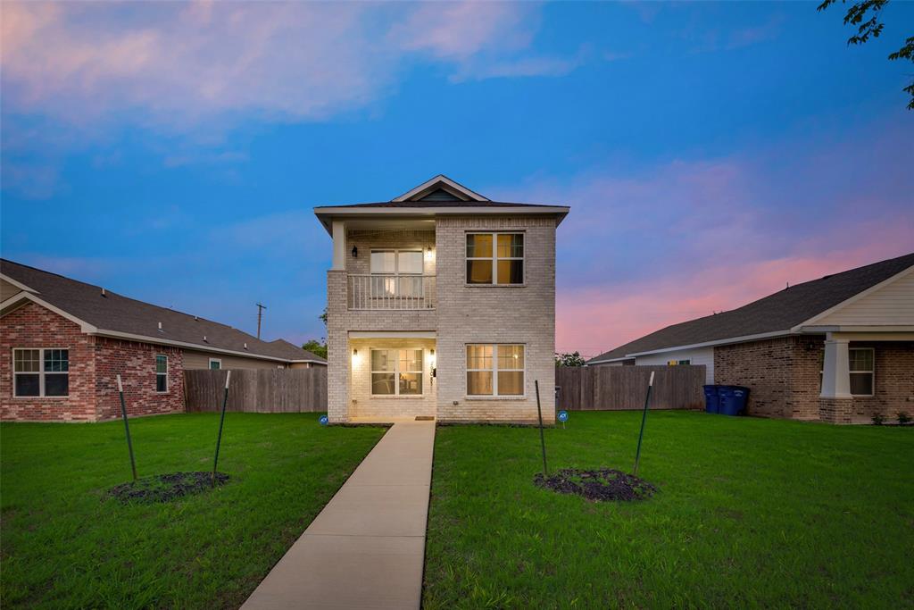 a front view of a house with a yard