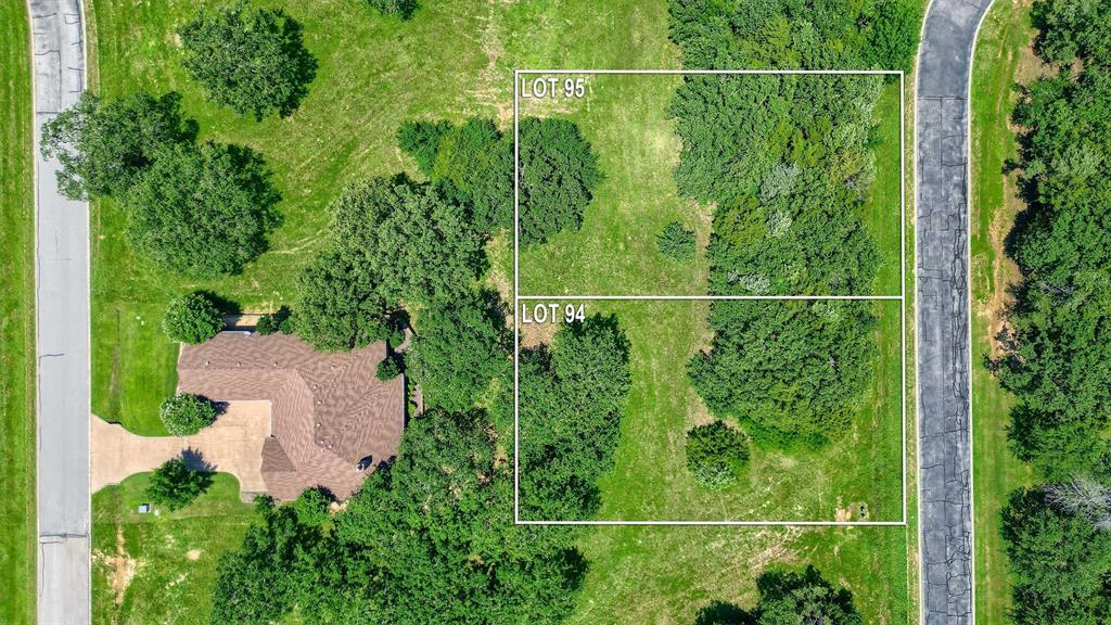 an aerial view of a house and trees all around