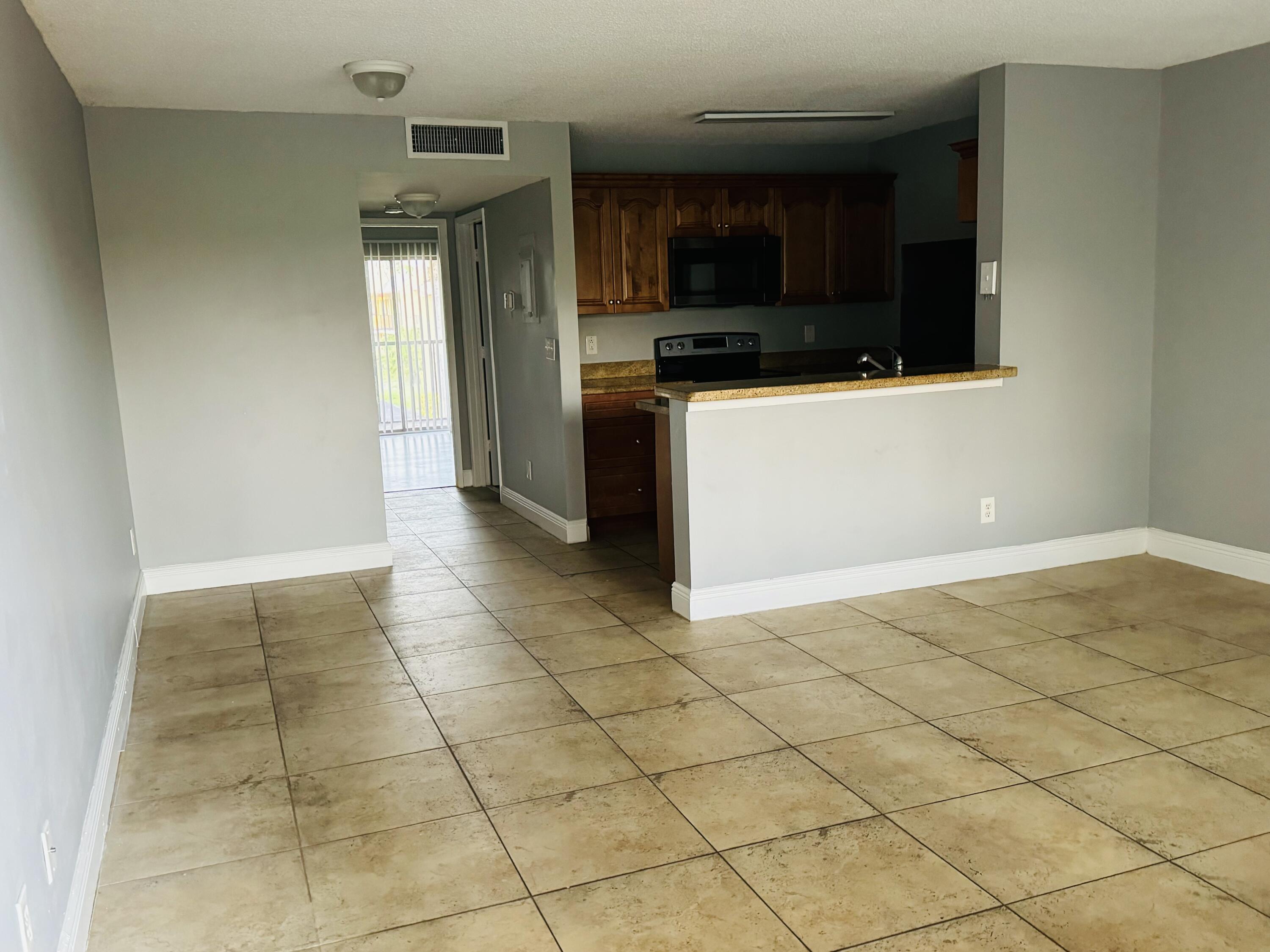 a view of a utility room with cabinets