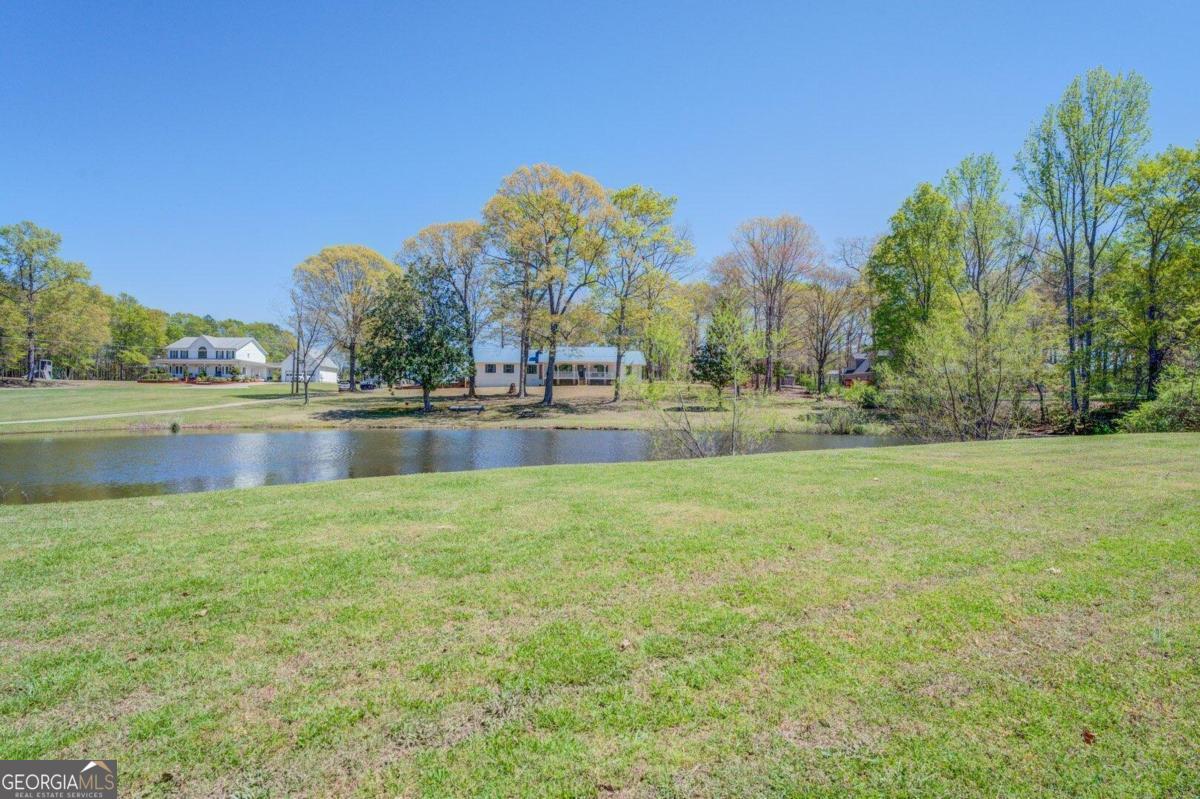 a view of a lake with houses in the background