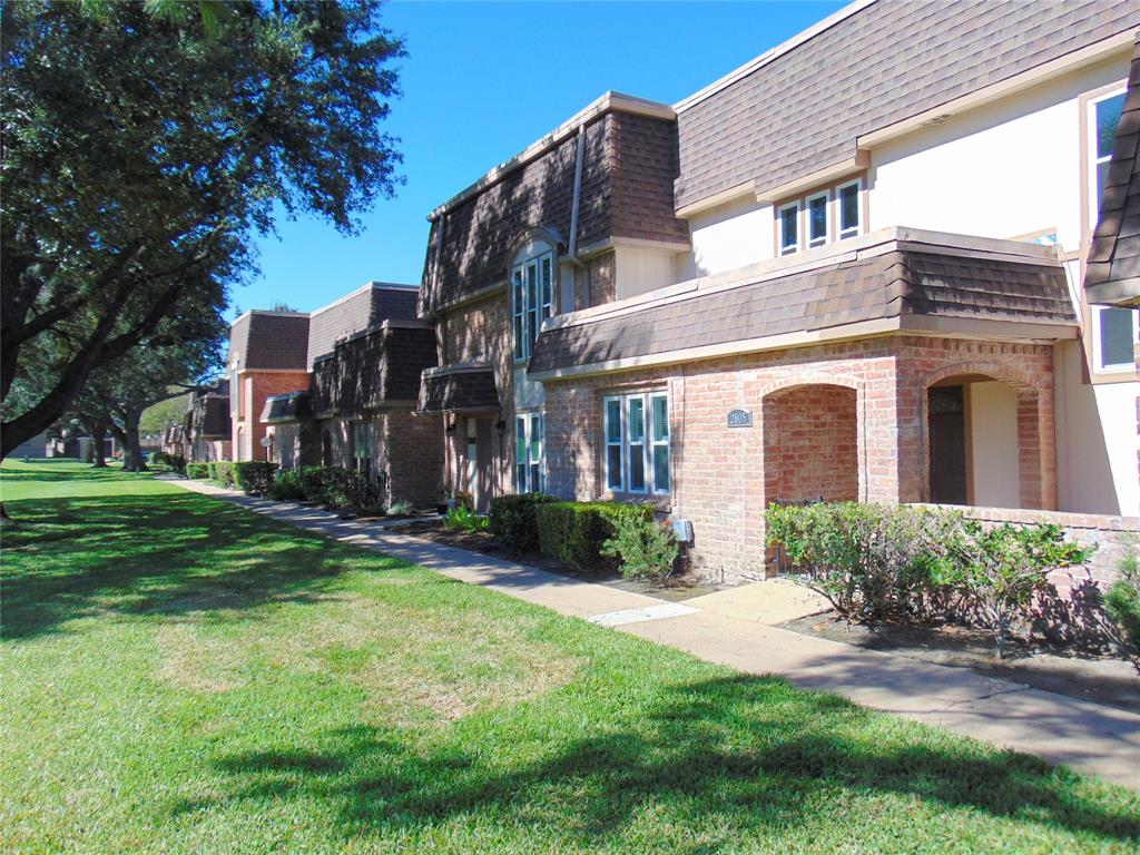 a brick building with a yard in front of it