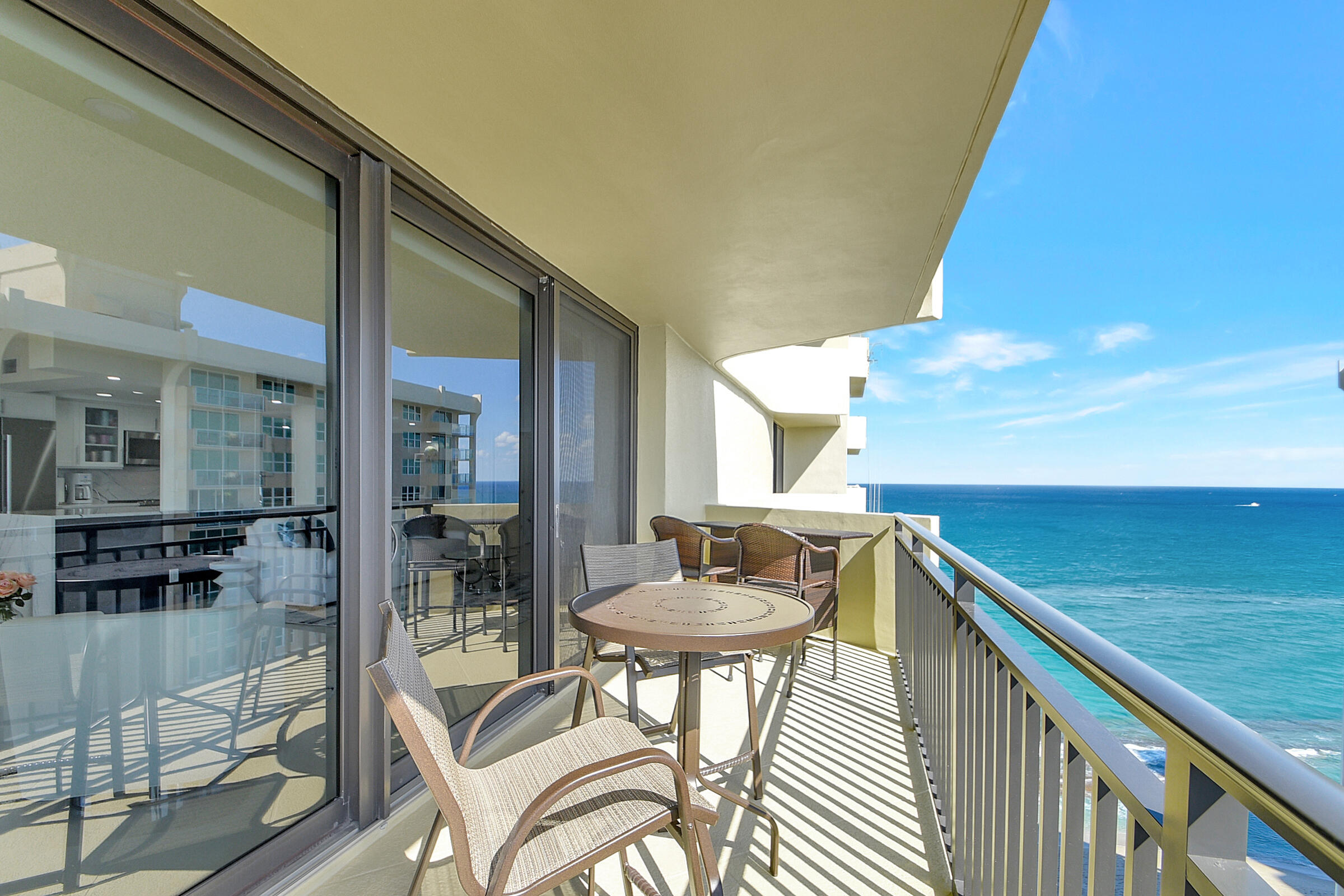 a balcony with table and chairs