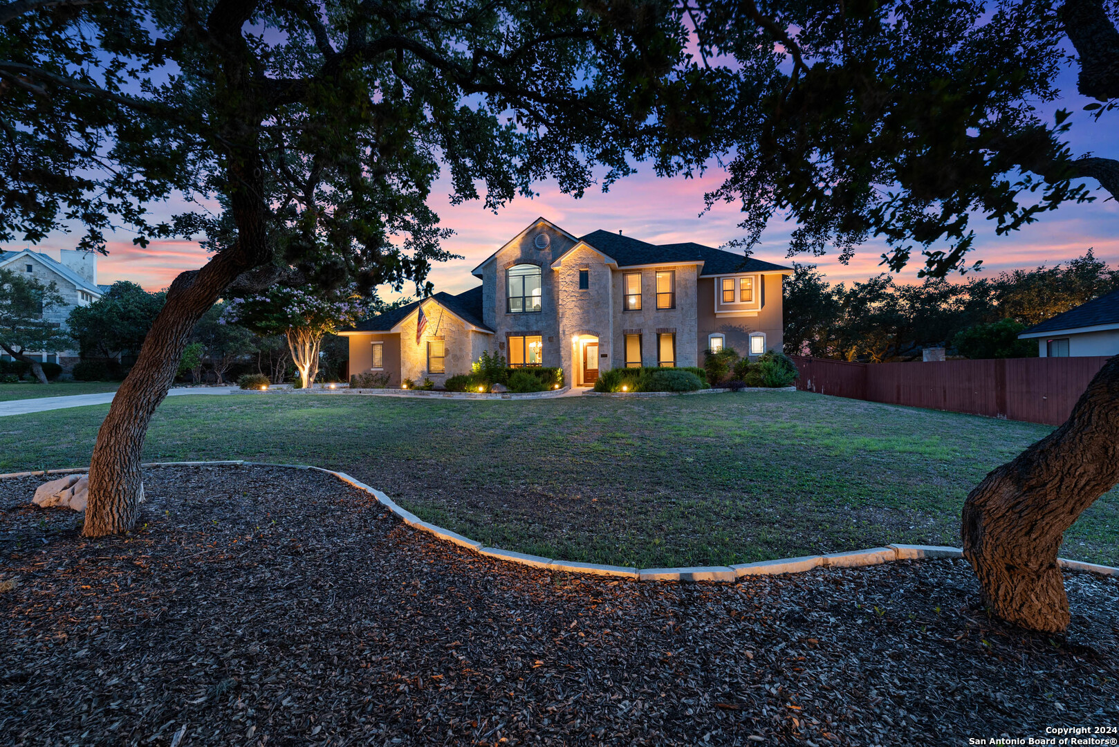 a view of a white house with a yard