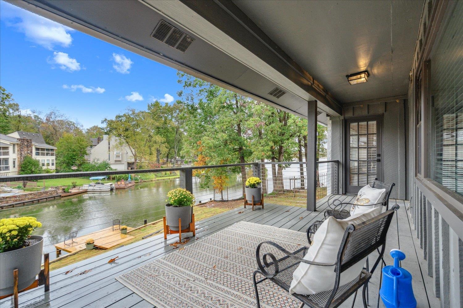 a balcony with wooden floor and outdoor seating