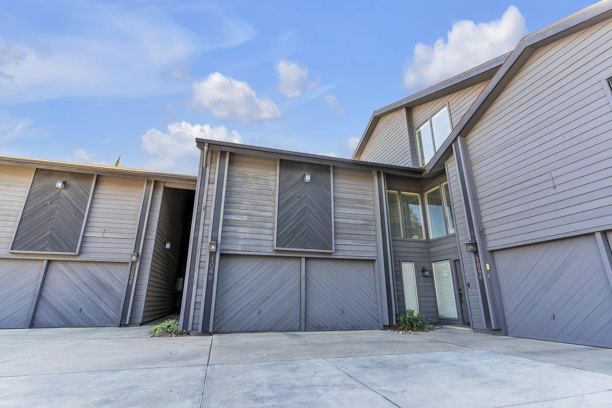 a view of a house with a wooden fence