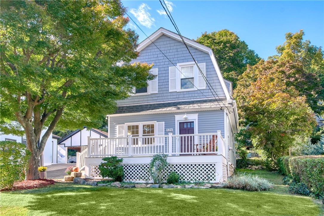 Front of house with a yard, an outbuilding, and a deck