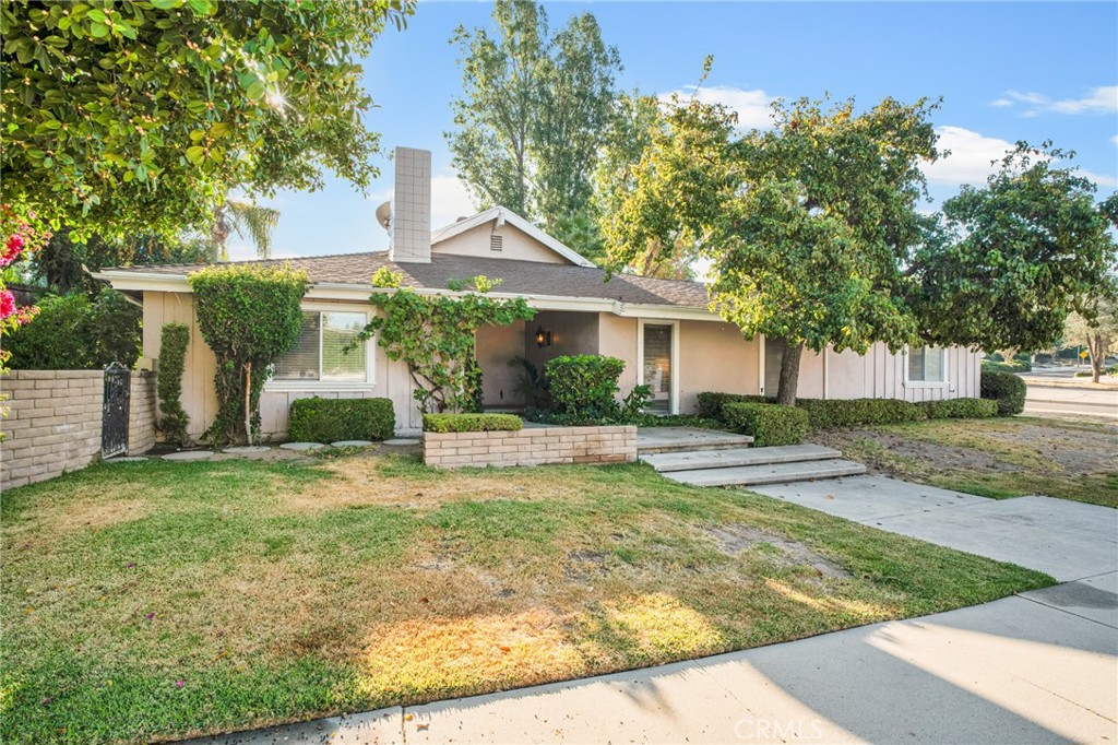 a view of a house with a yard and tree s