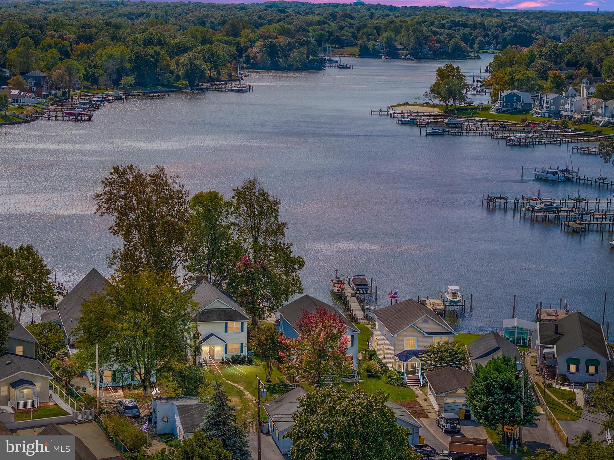 an aerial view of a house with outdoor space and lake view