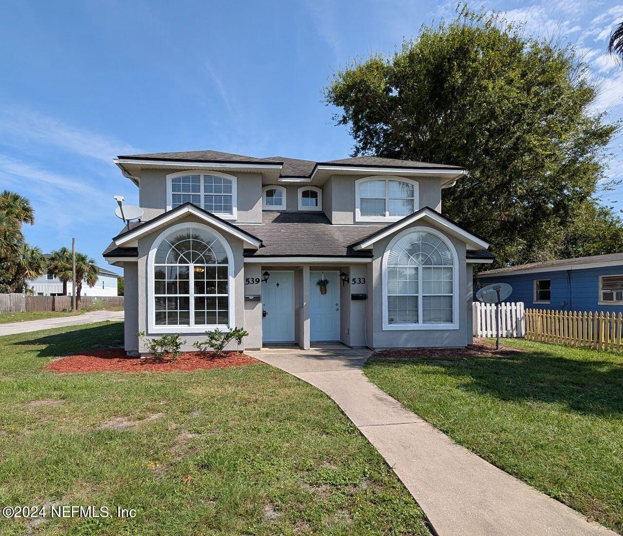 a front view of a house with a yard