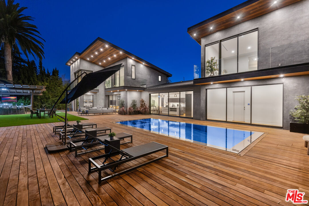 a view of a house with swimming pool and sitting area