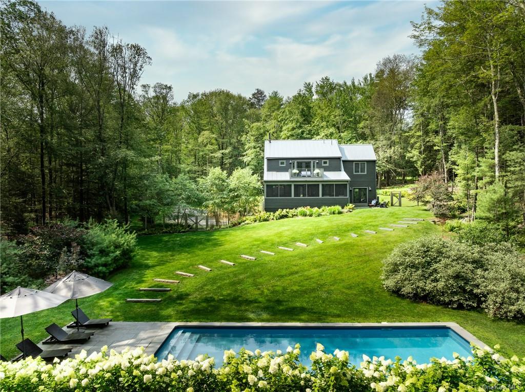 a view of a swimming pool with a yard