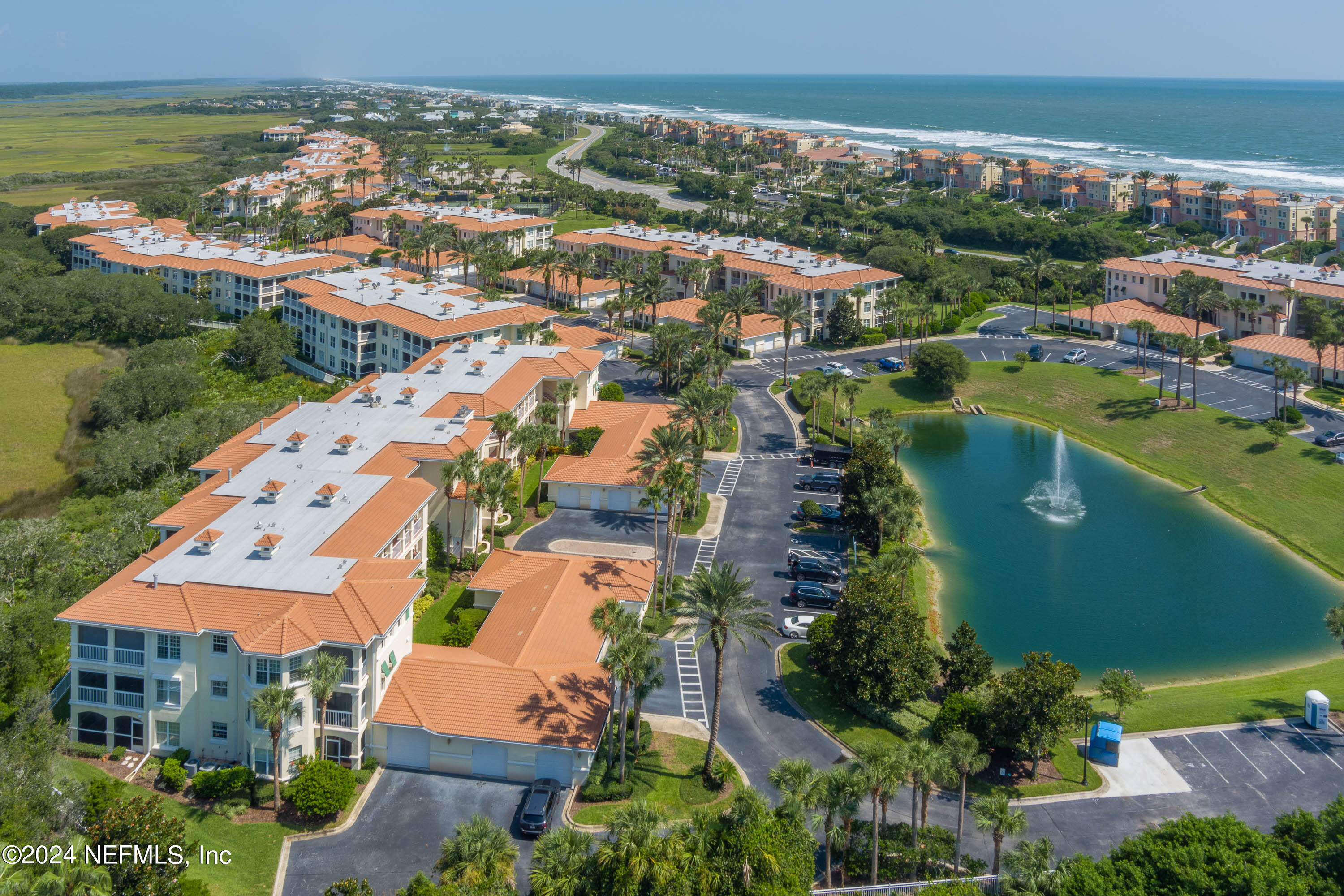 an aerial view of residential houses with outdoor space and river