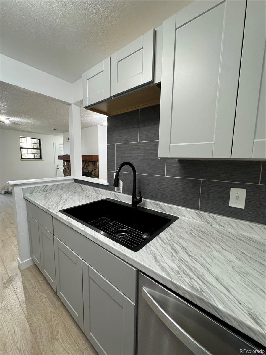 a kitchen with a sink and cabinets