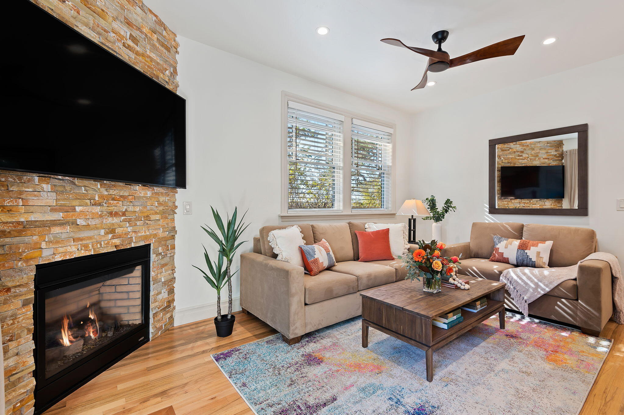 a living room with furniture a fireplace and a flat screen tv