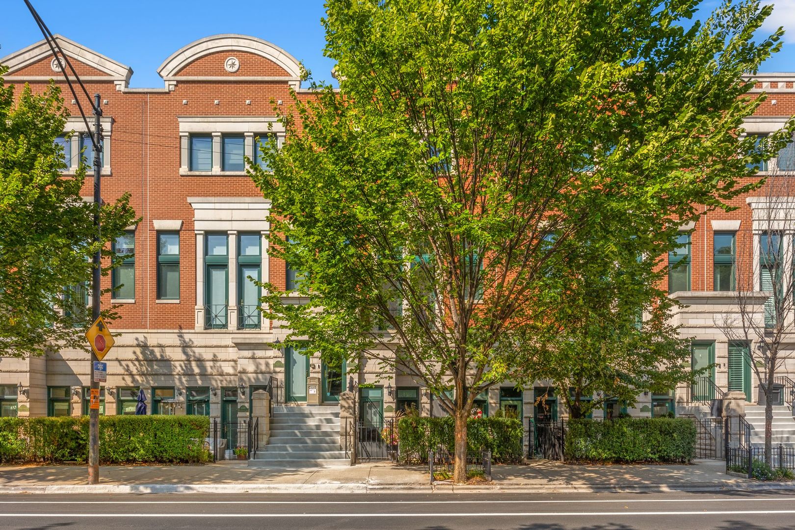 a front view of a building with a garden