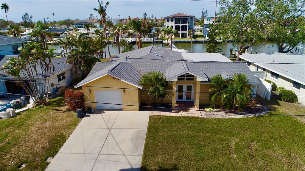 an aerial view of a house with swimming pool and porch