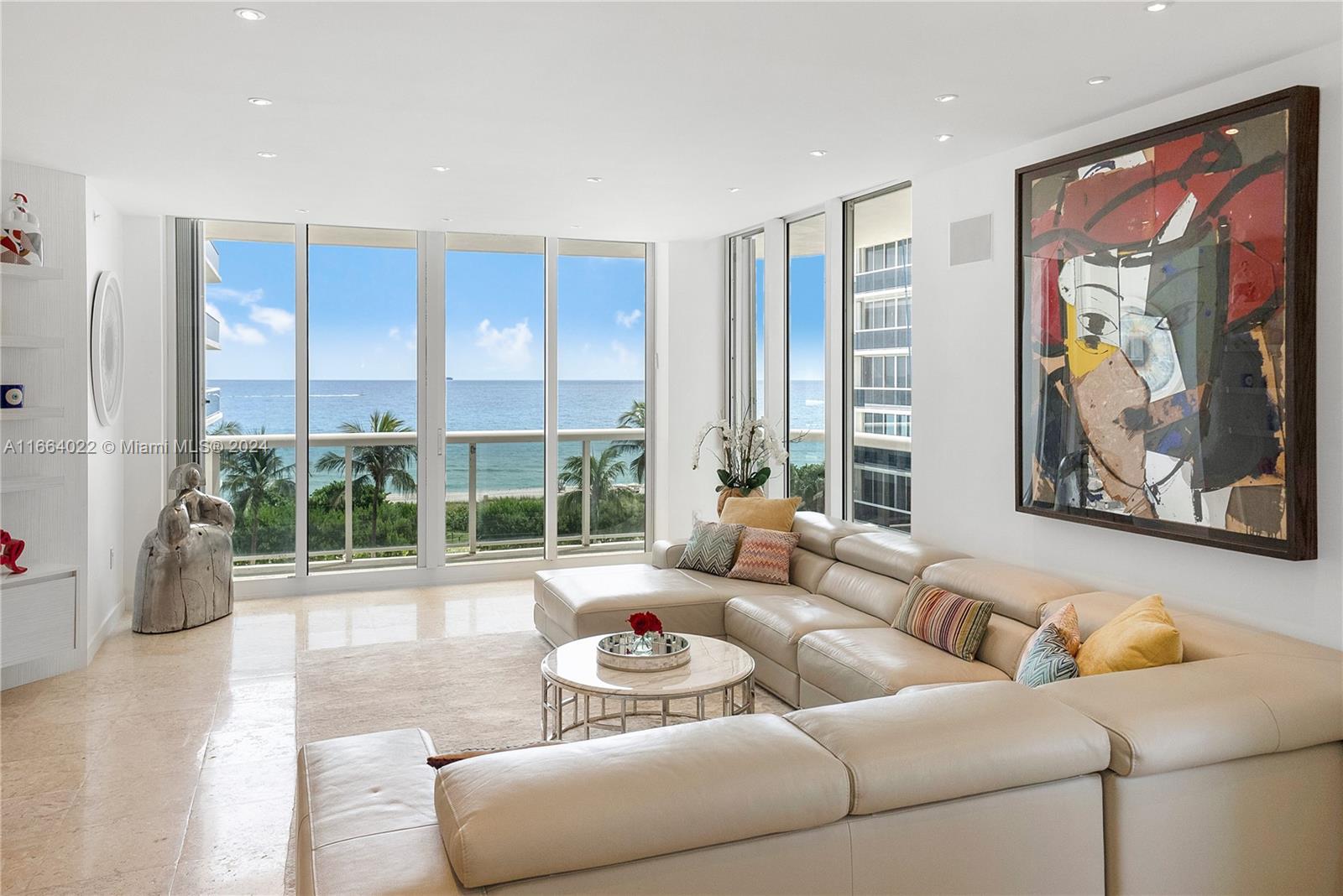 a living room with furniture and large windows