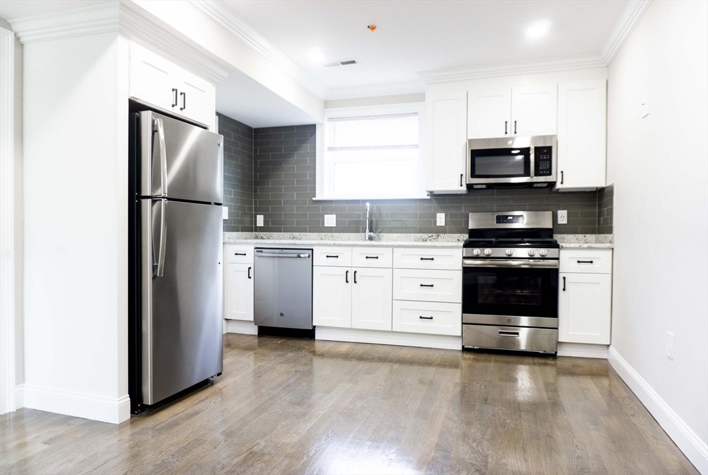 a kitchen with stainless steel appliances a refrigerator stove and sink