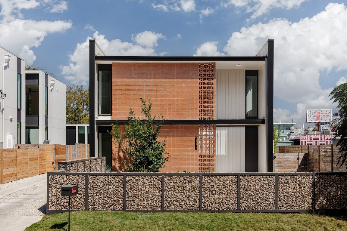 a front view of a house with large windows