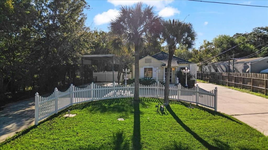 Front of main residence with circular driveway and RV parking on side of home