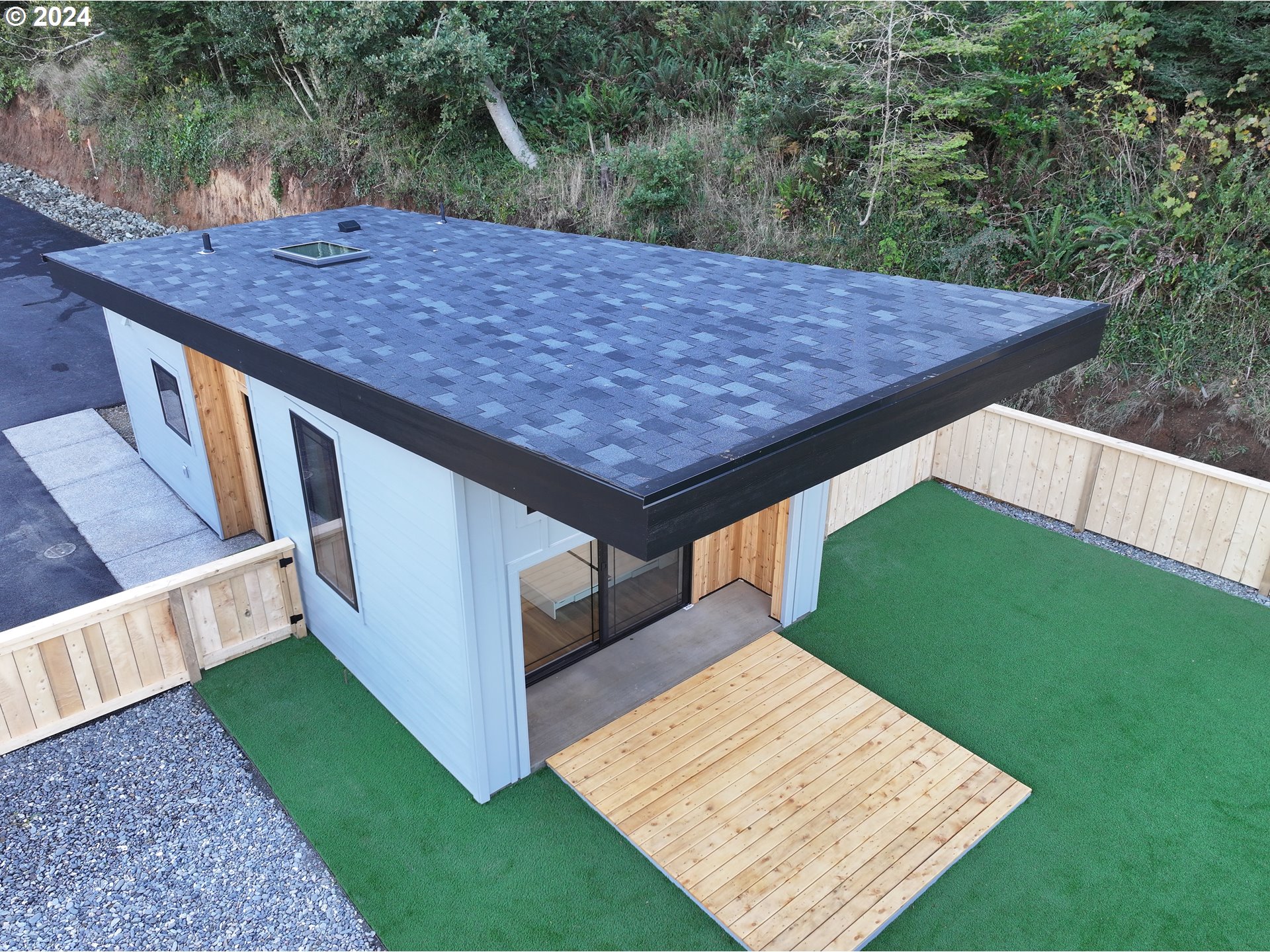 a view of a backyard with a wooden floor and fence