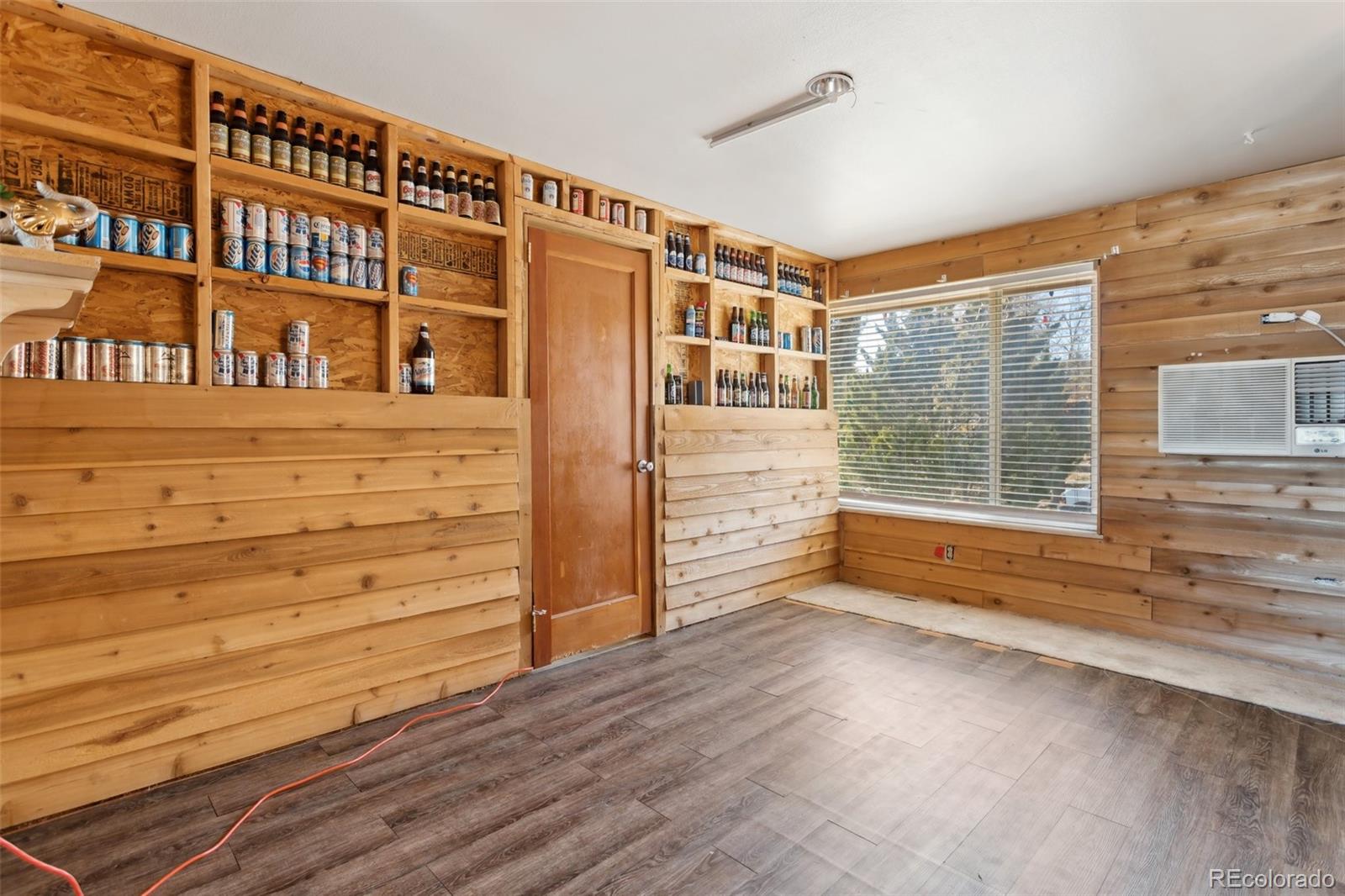 a view of livingroom with an empty space wooden floor and window