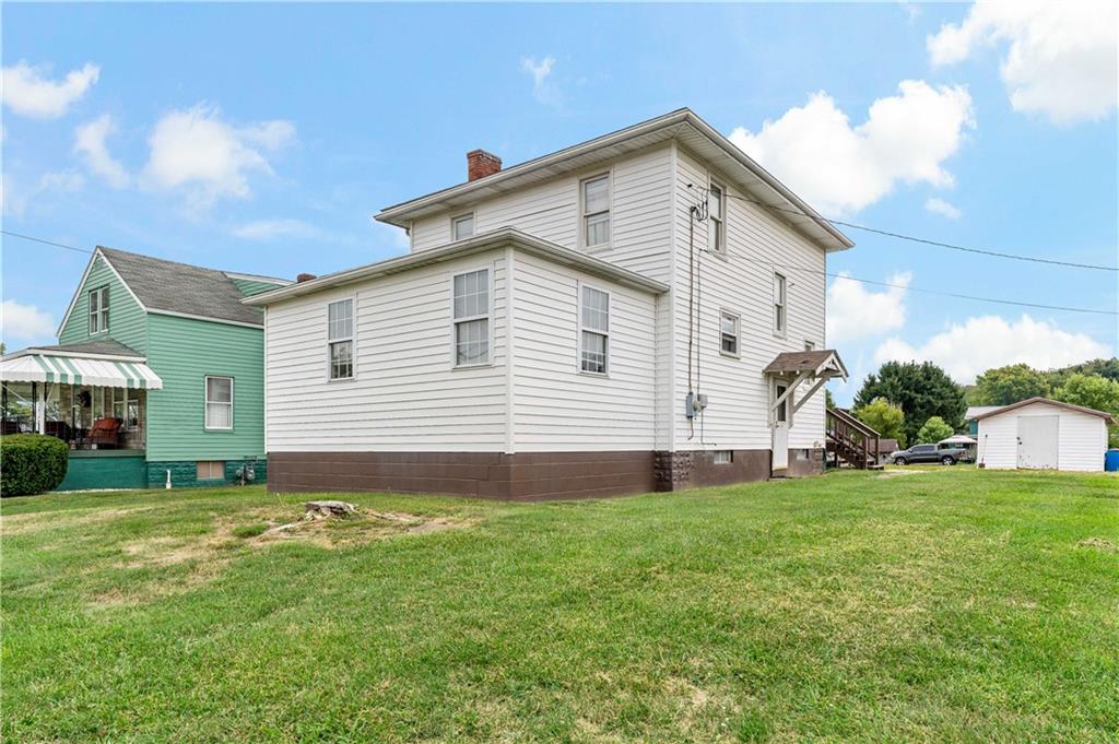 a front view of house with yard and green space