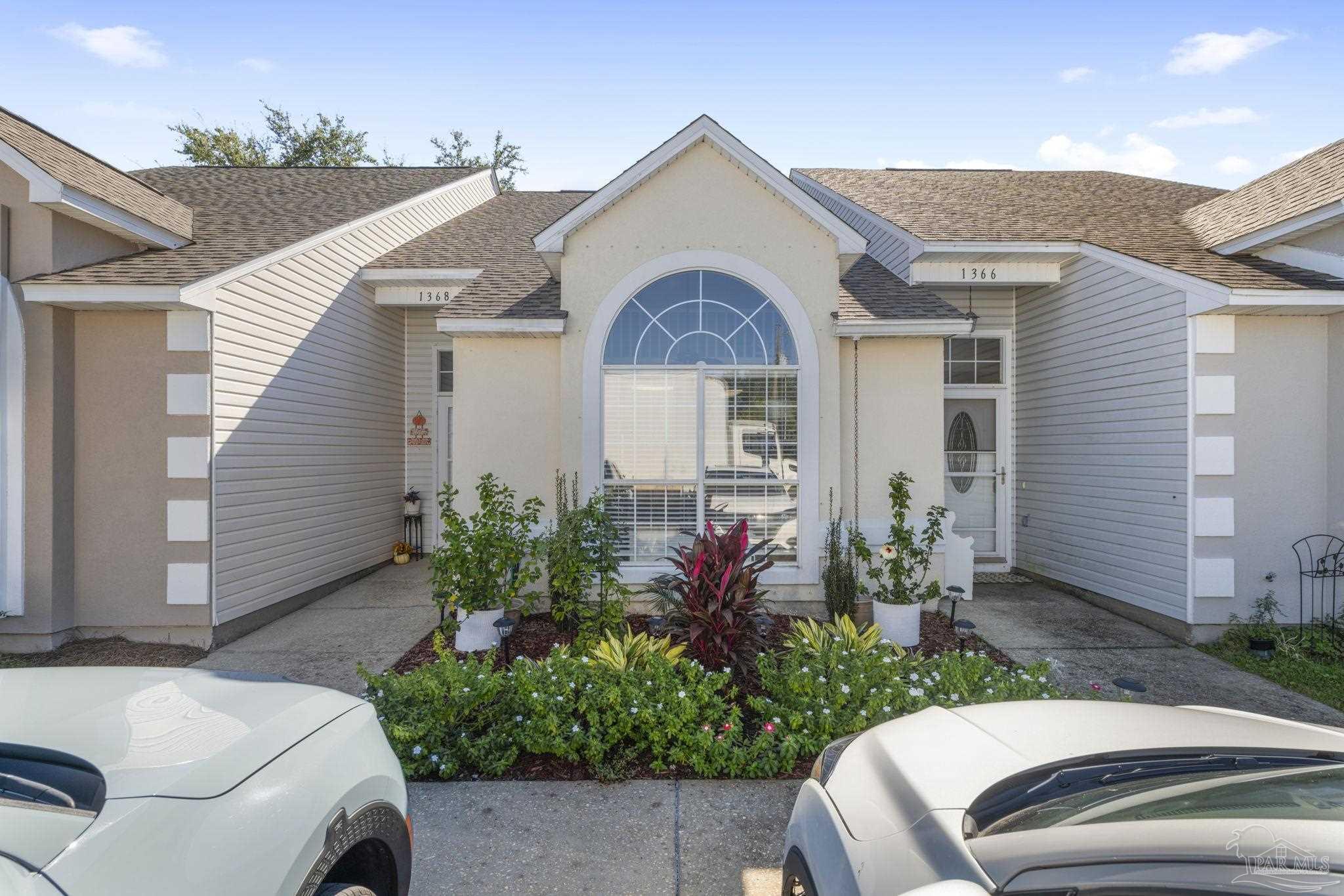 a front view of a house with garden