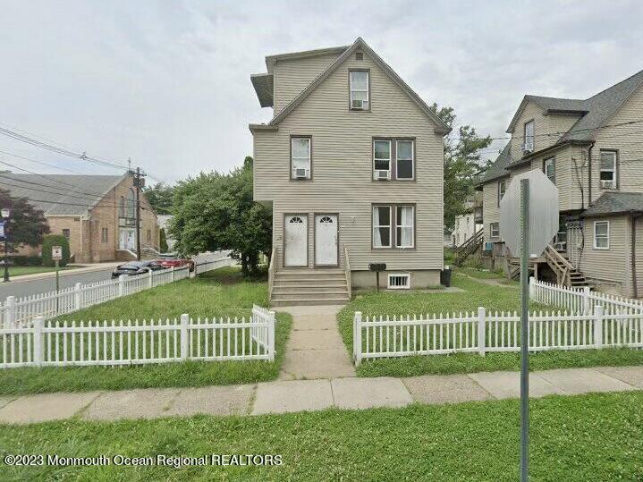 a view of a house with a yard and a garden