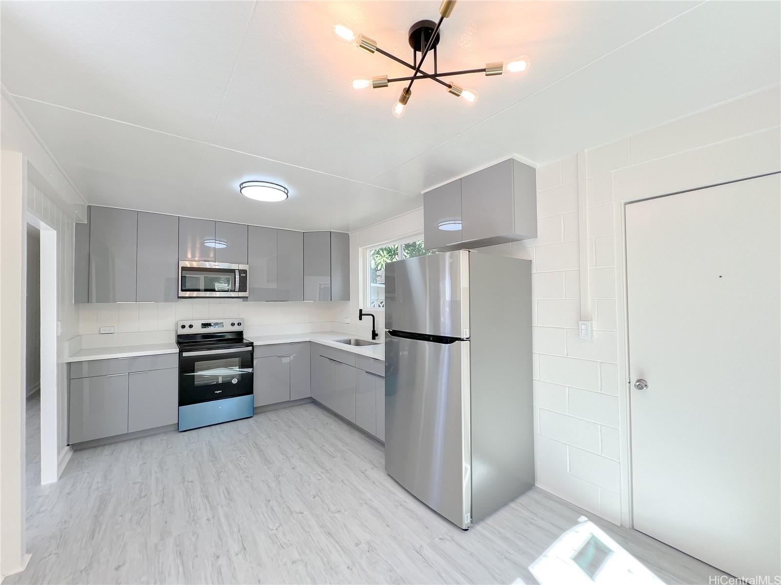 a kitchen with stainless steel appliances a refrigerator and a stove top oven