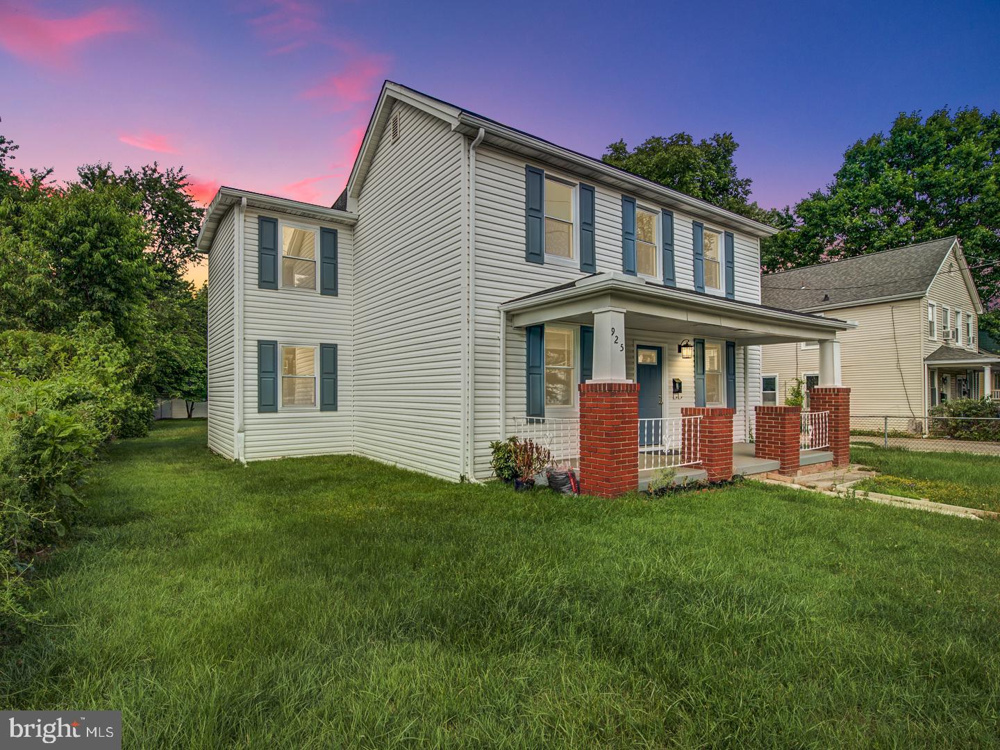 a front view of a house with a yard and porch