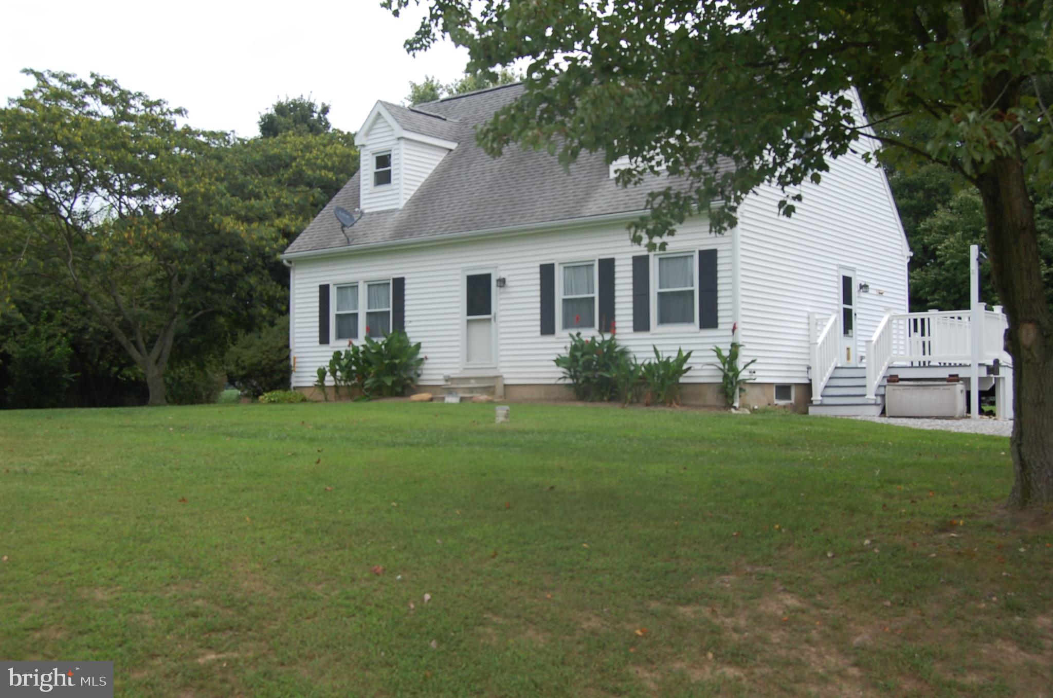 a view of a house with backyard garden and plants