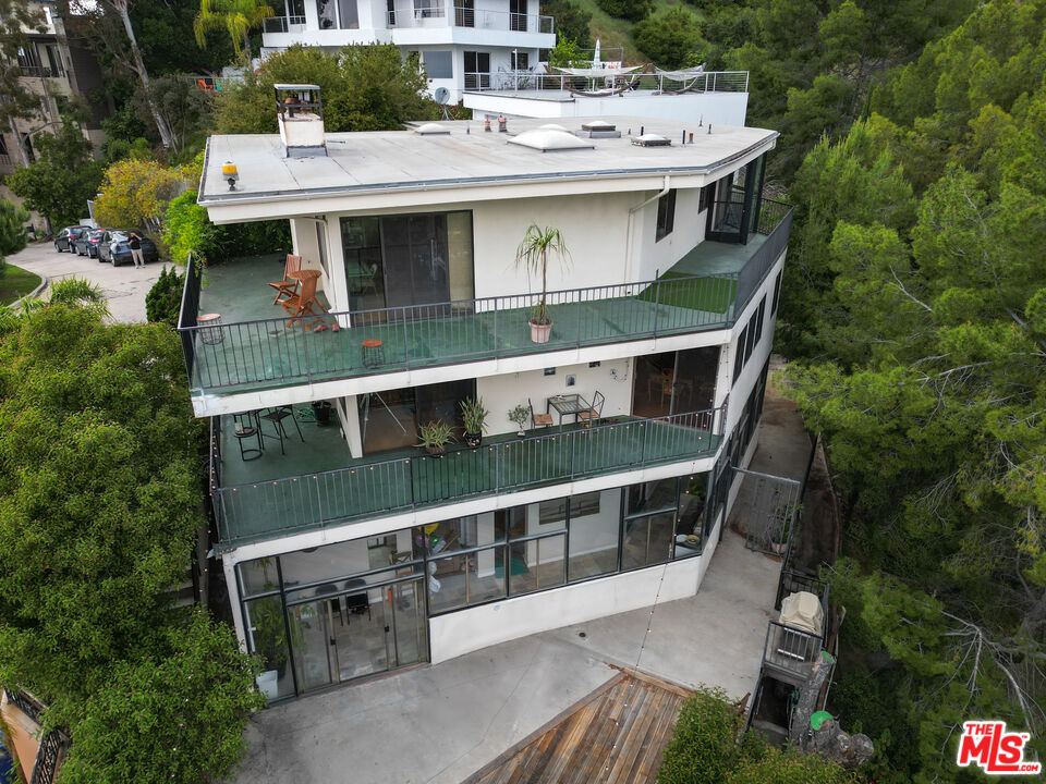 a view of a house with roof deck front of house