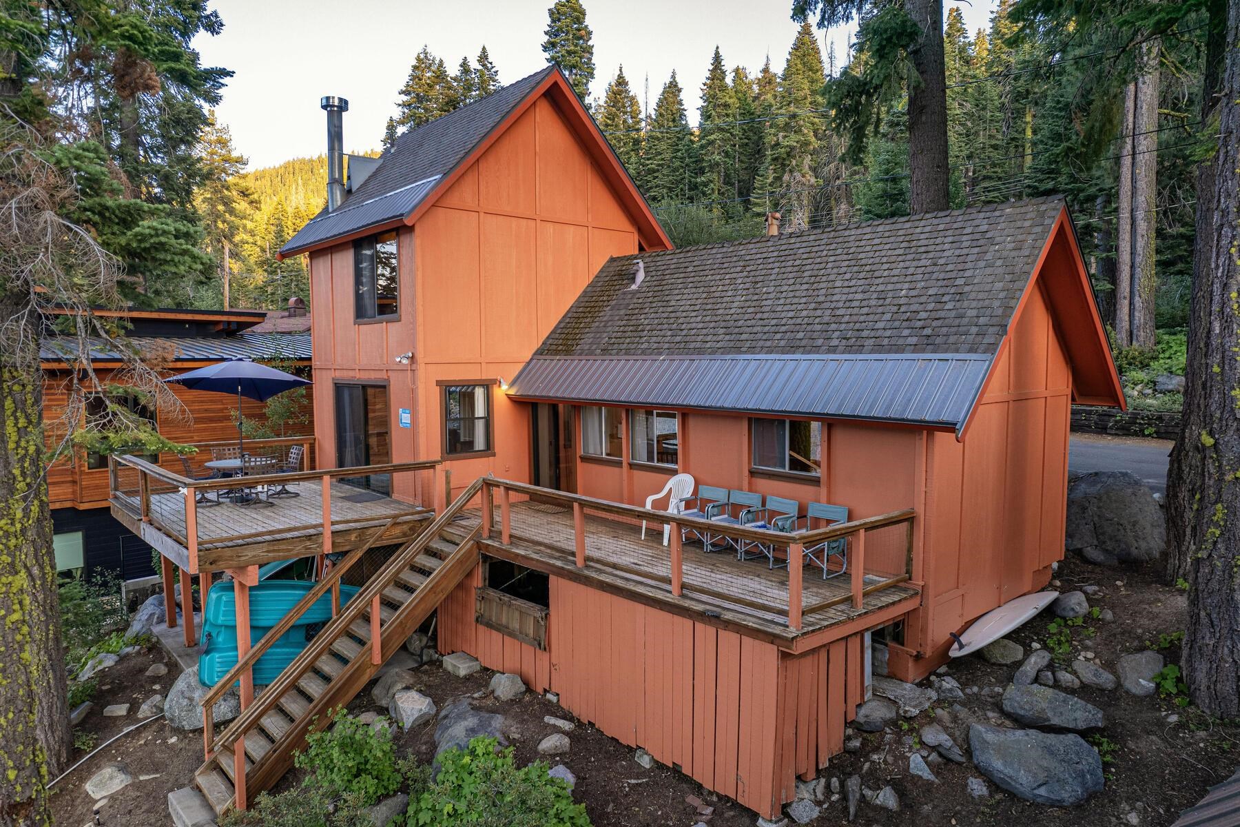 an aerial view of a house with balcony and trees