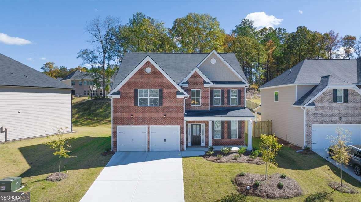 a front view of a house with a yard