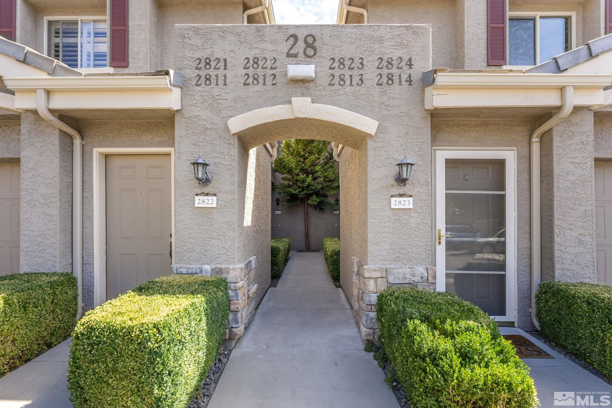 a front view of a house with a garden