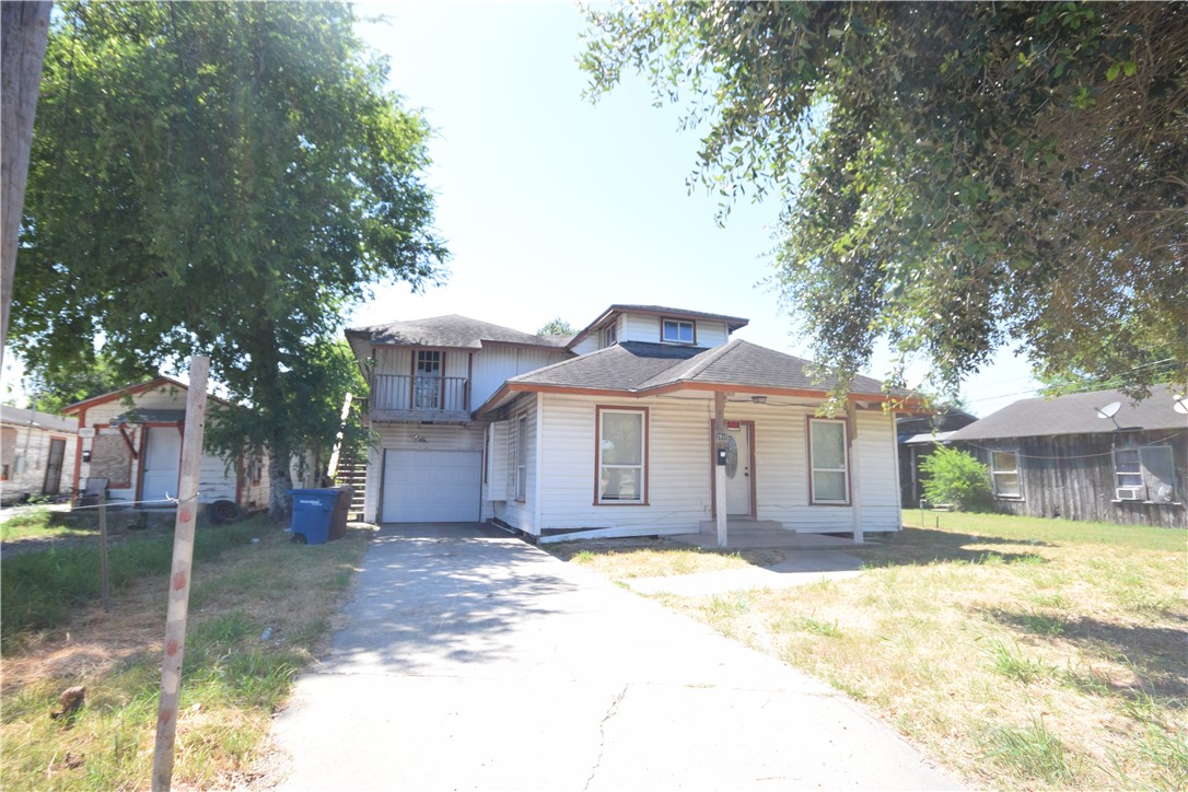 a front view of a house with a yard garage and outdoor seating