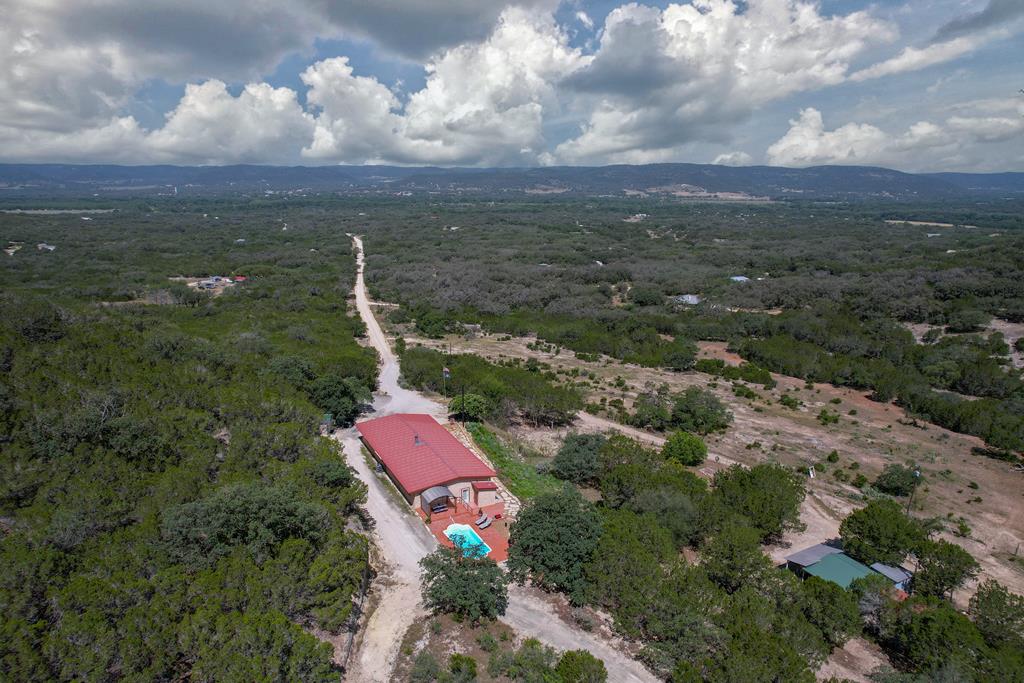 a aerial view of a house with a yard and lake view