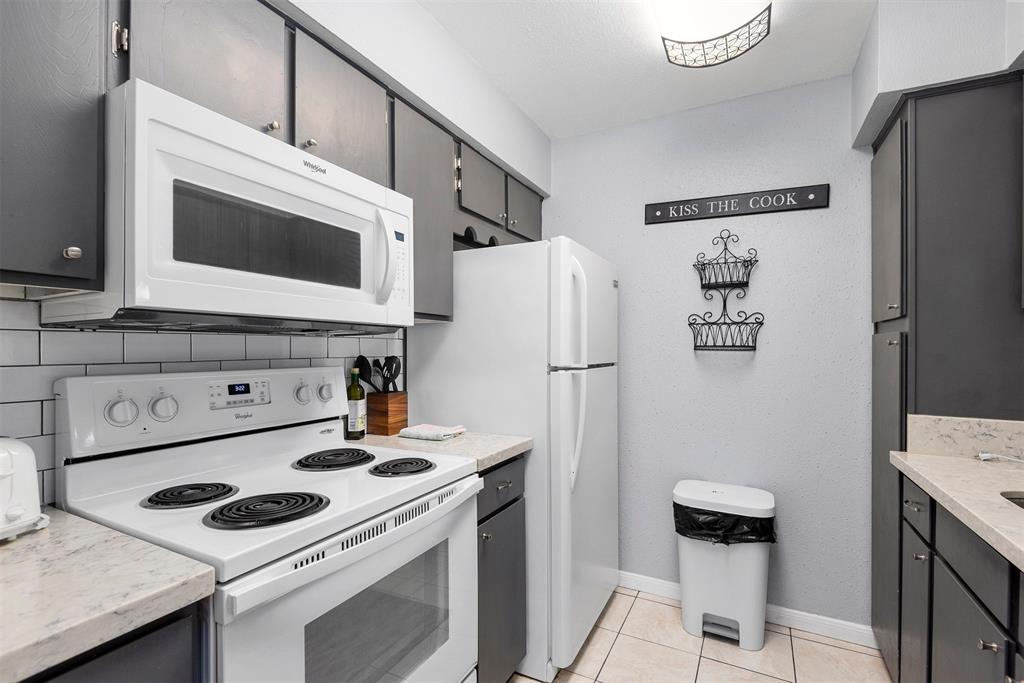 a kitchen with stainless steel appliances a stove a refrigerator and a cabinets