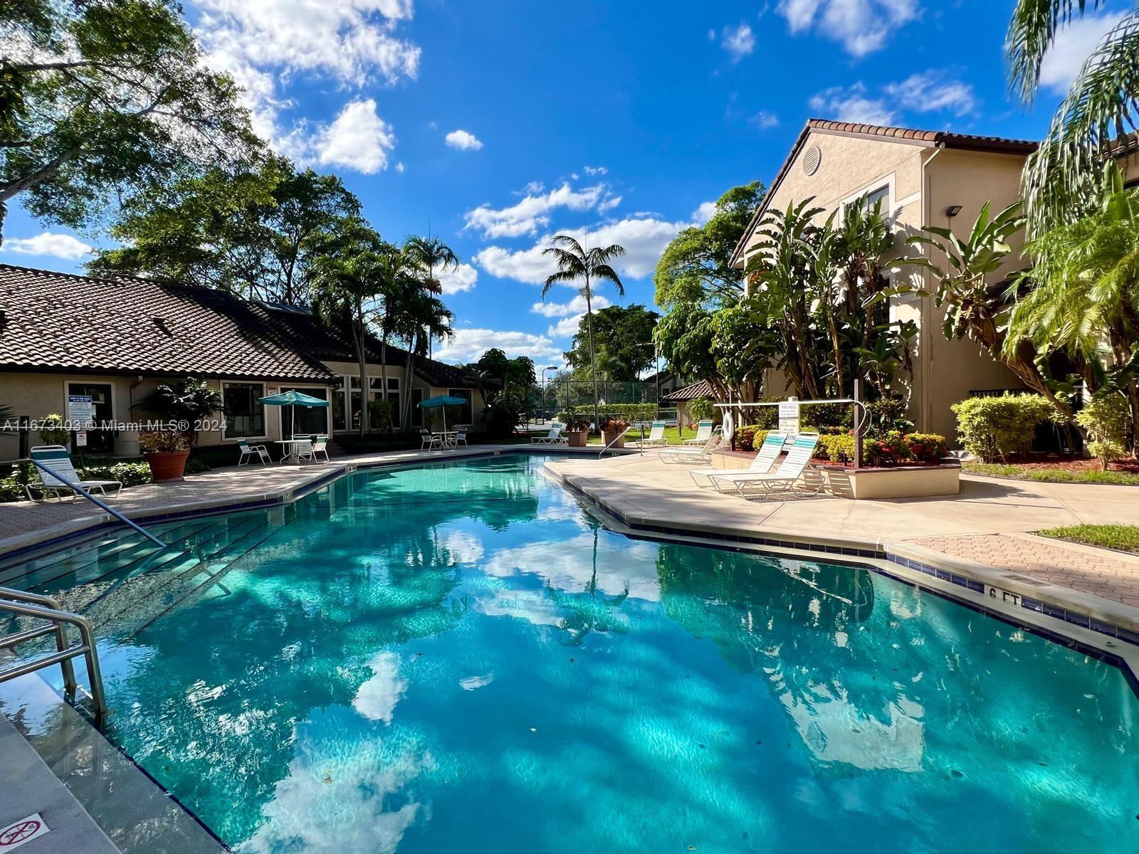 a view of an house with backyard space and sitting area