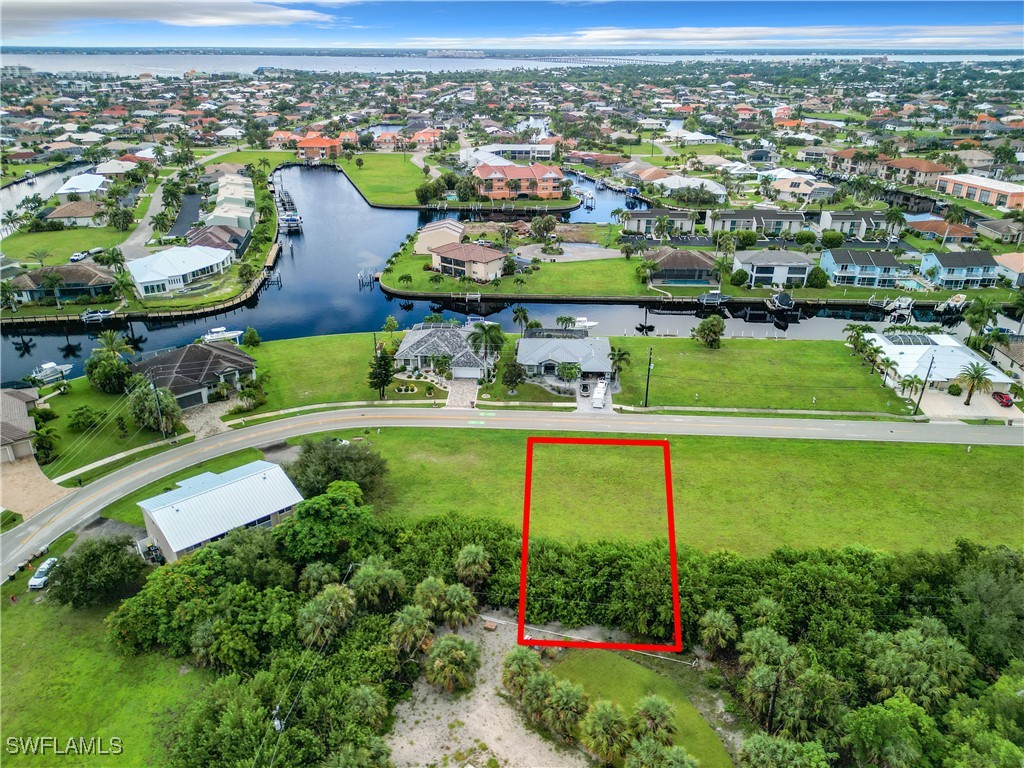 an aerial view of a houses with outdoor space and lake view