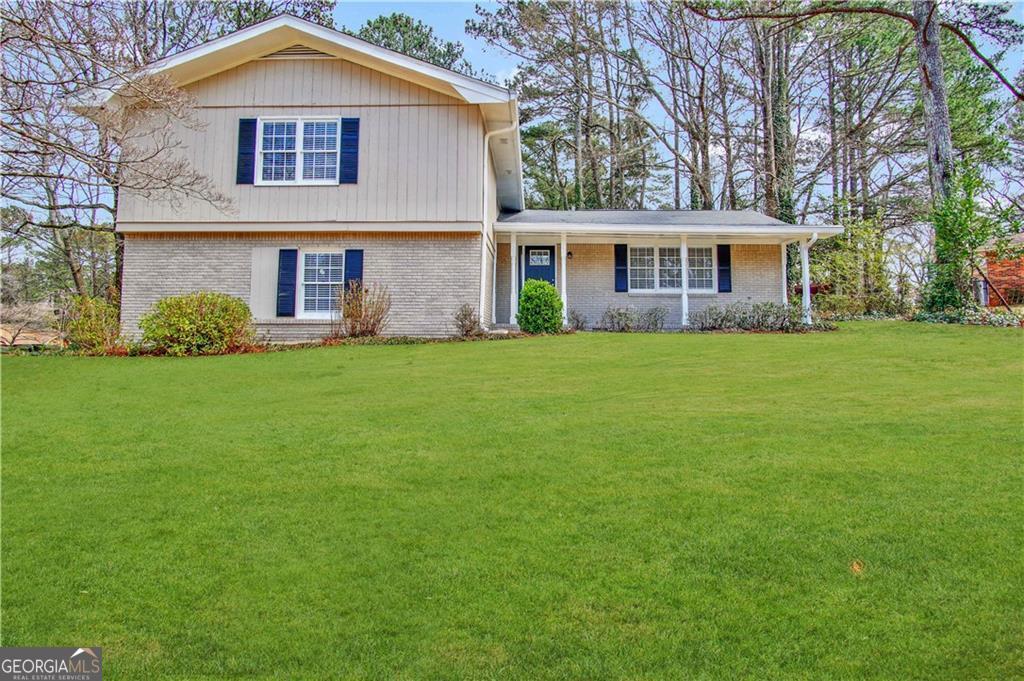 a front view of a house with a garden