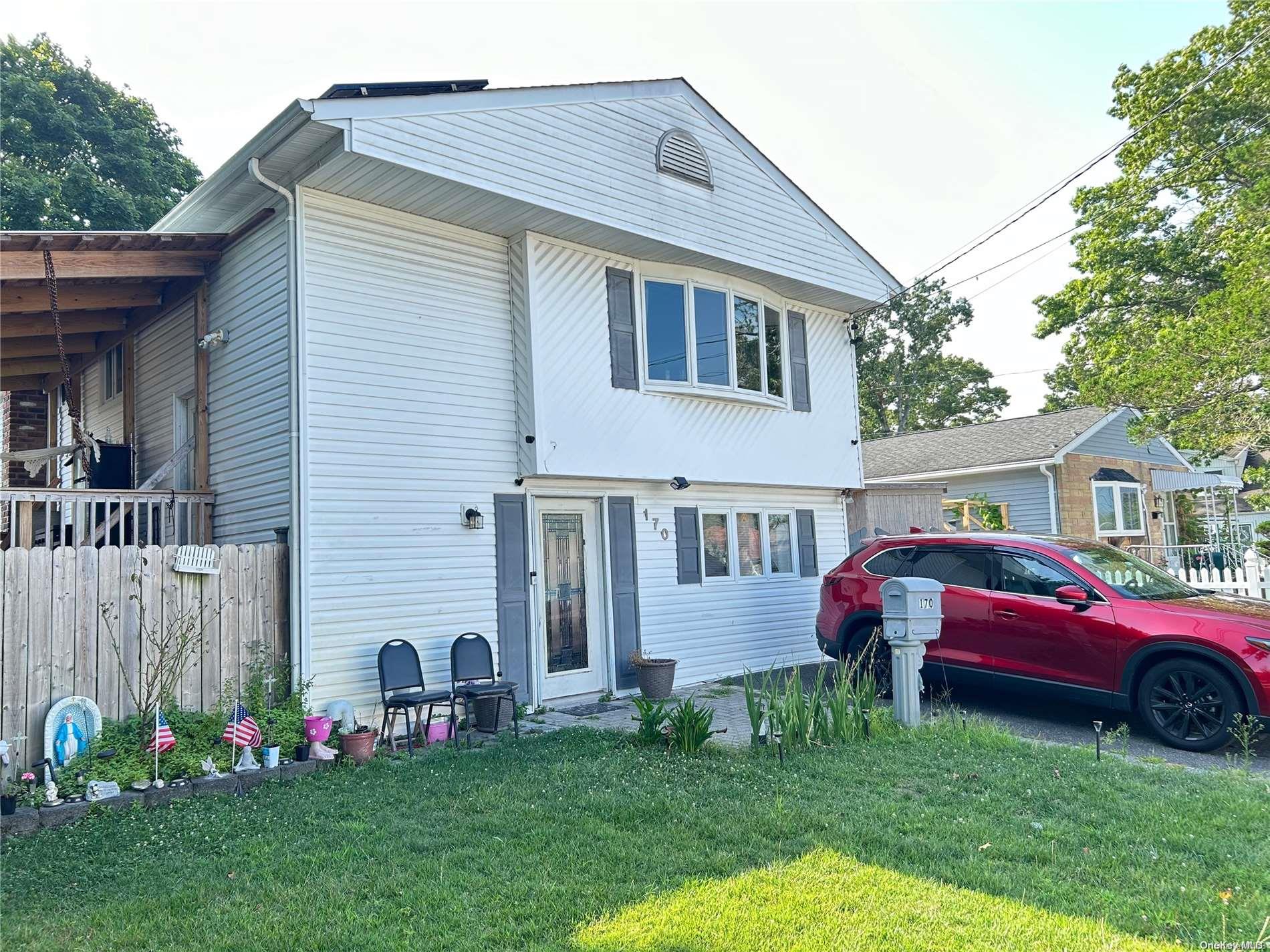 a front view of a house with a garden and deck