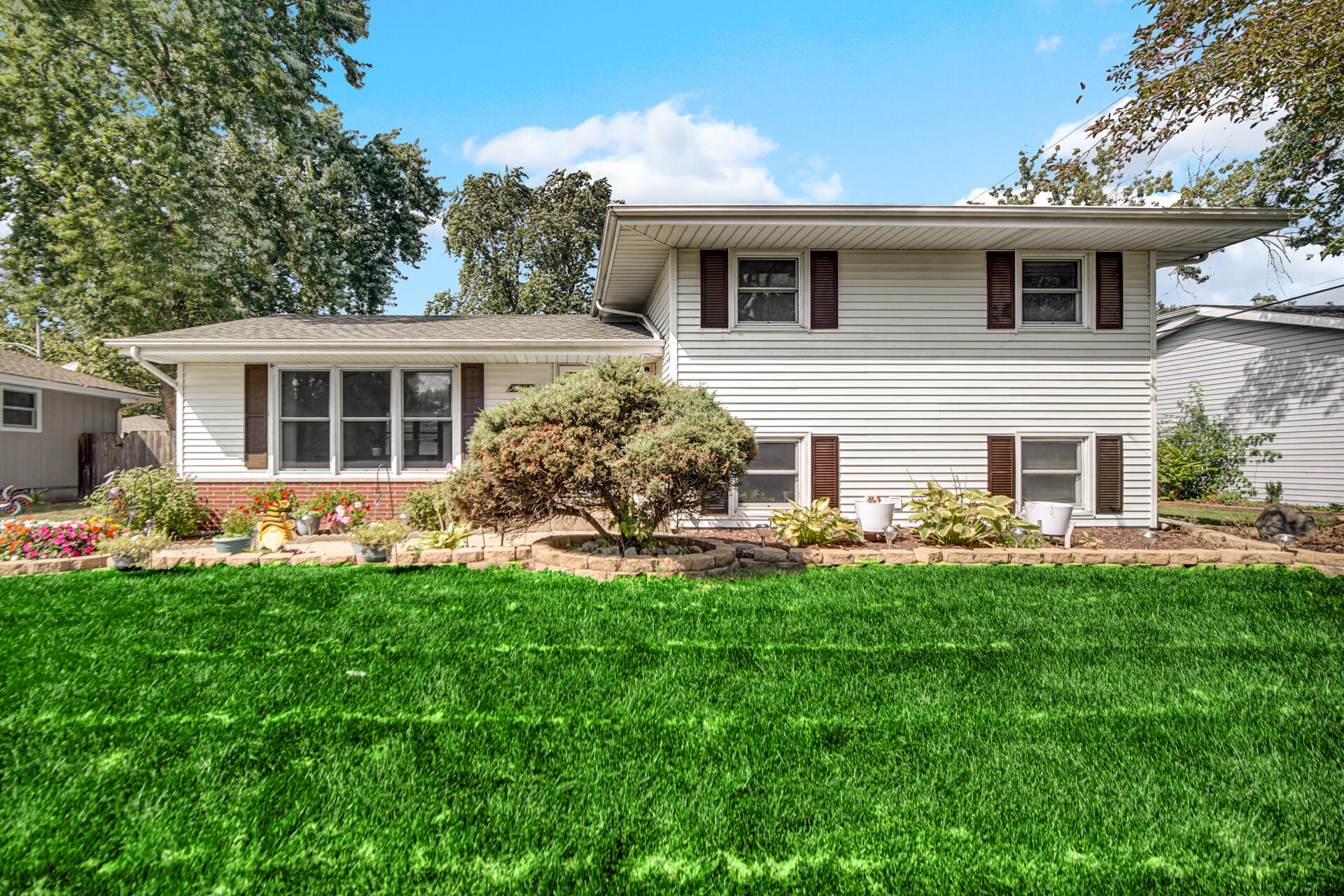 a front view of a house with a garden