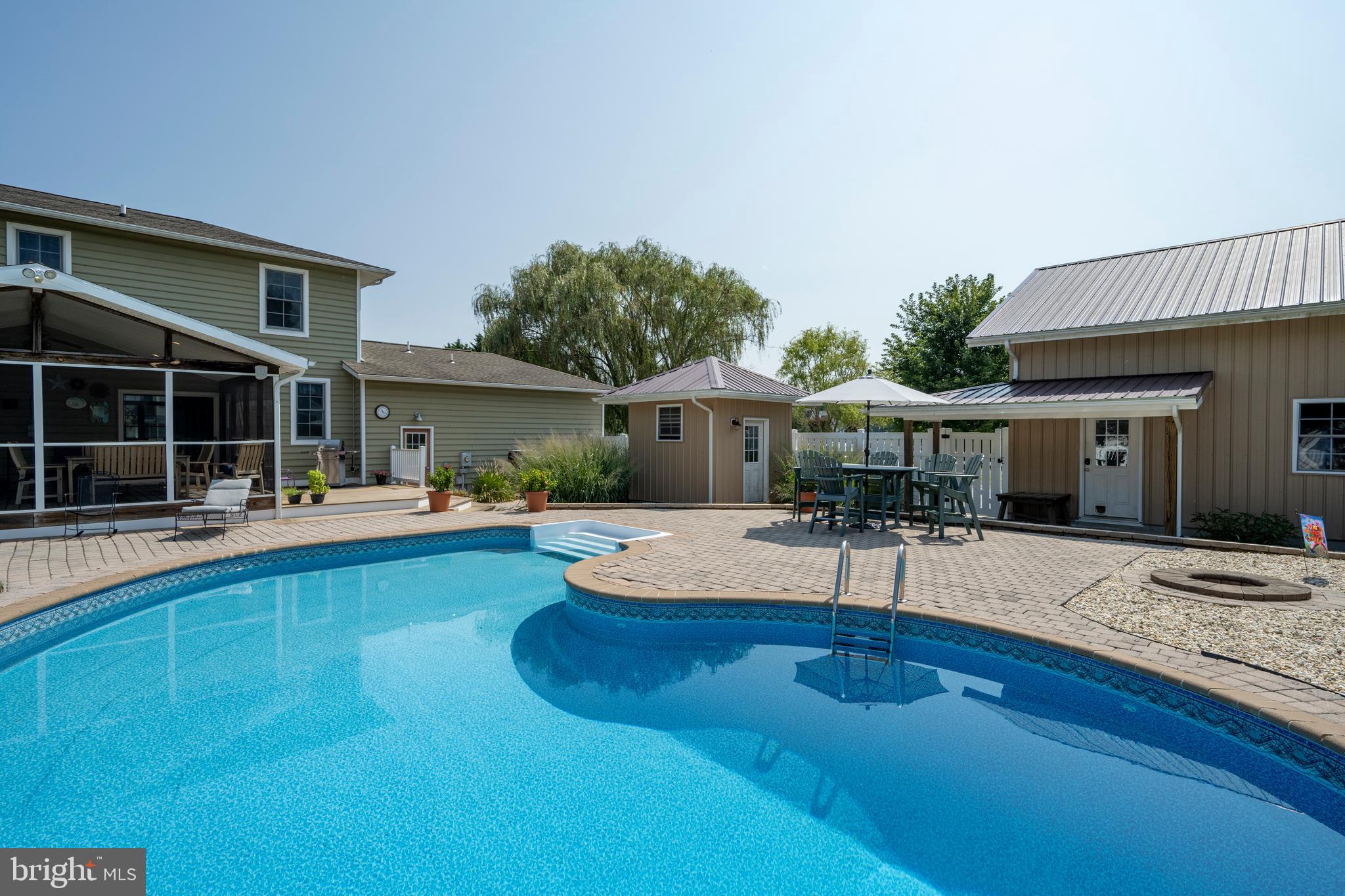 a view of house with swimming pool and furniture