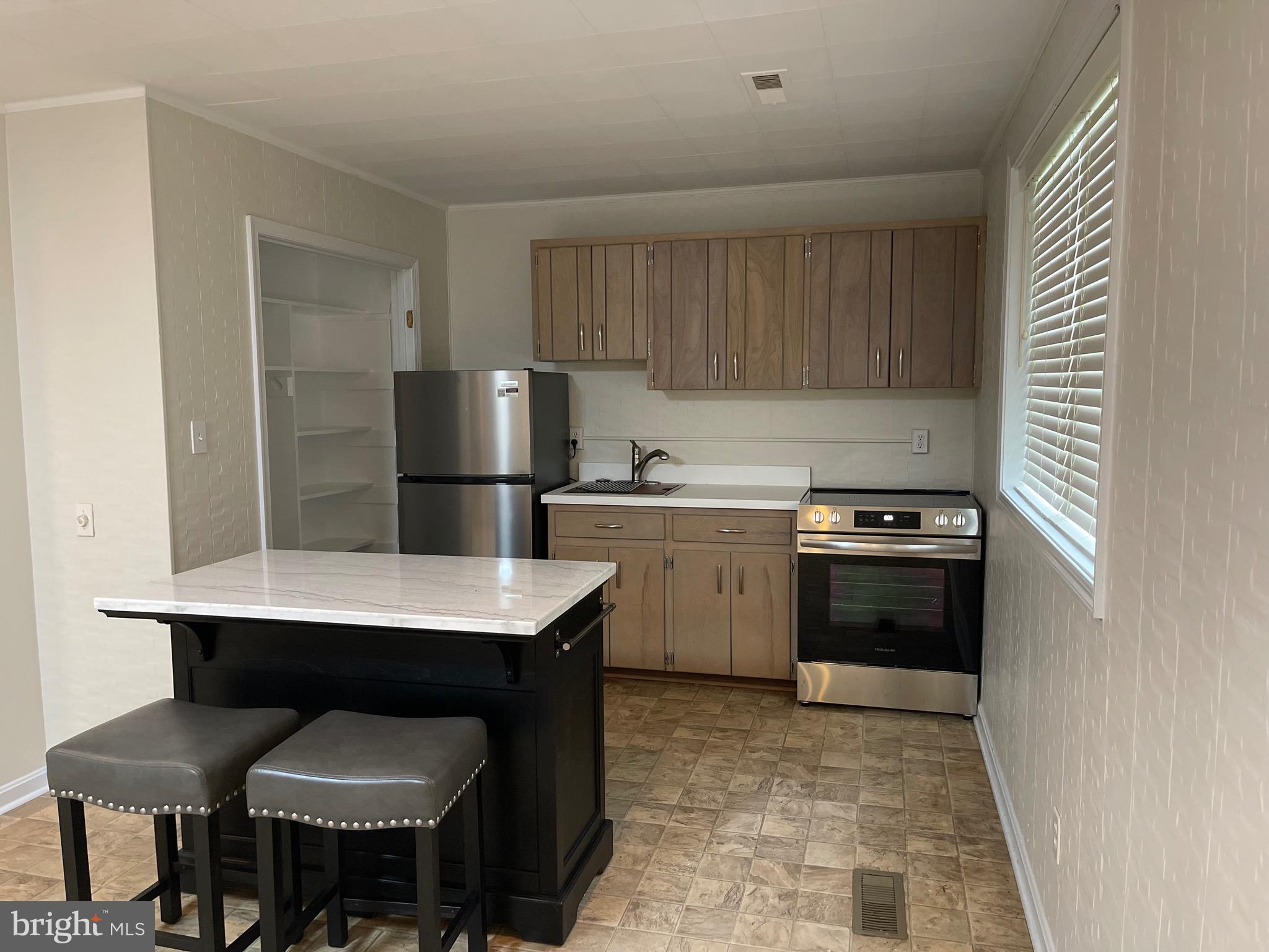 a kitchen with a sink cabinets and stainless steel appliances